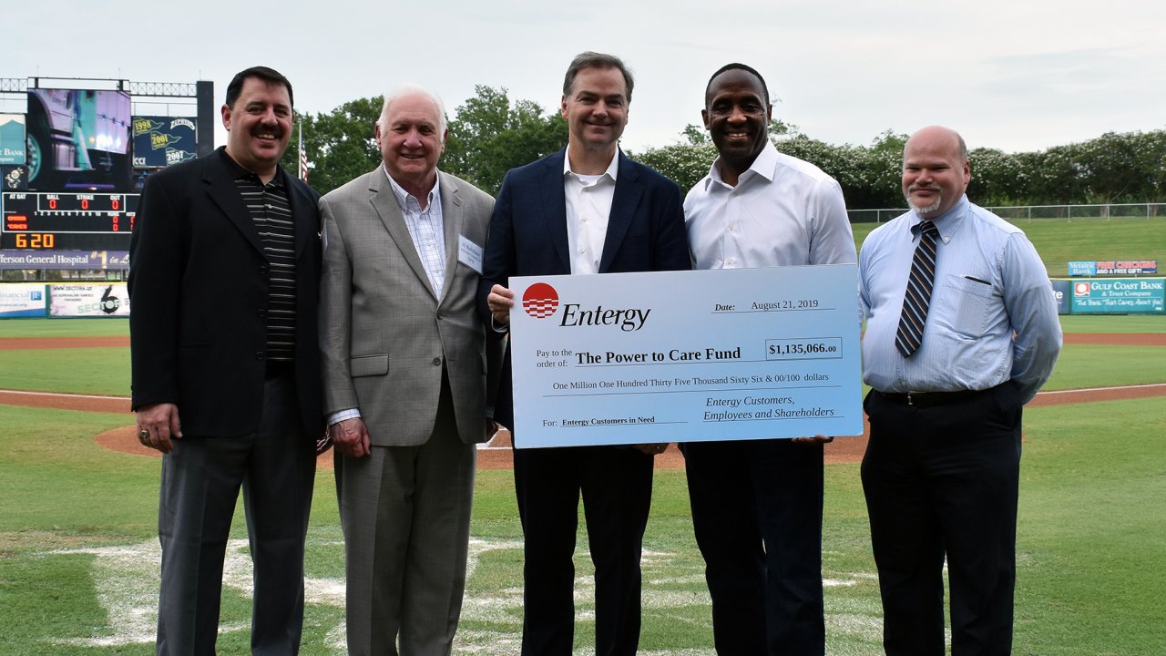 President and CEO of Entergy Louisiana Phillip May and president and CEO of Entergy New Orleans David Ellis (centered) were joined by nonprofit representatives for a check presentation at the New Orleans Baby Cakes baseball game on Wed., Aug. 21.